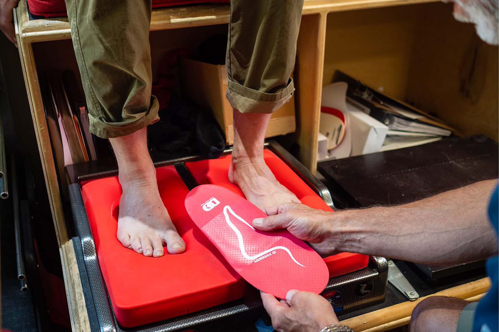 Bud Heishman helping a customer with custom insoles for their ski boots.