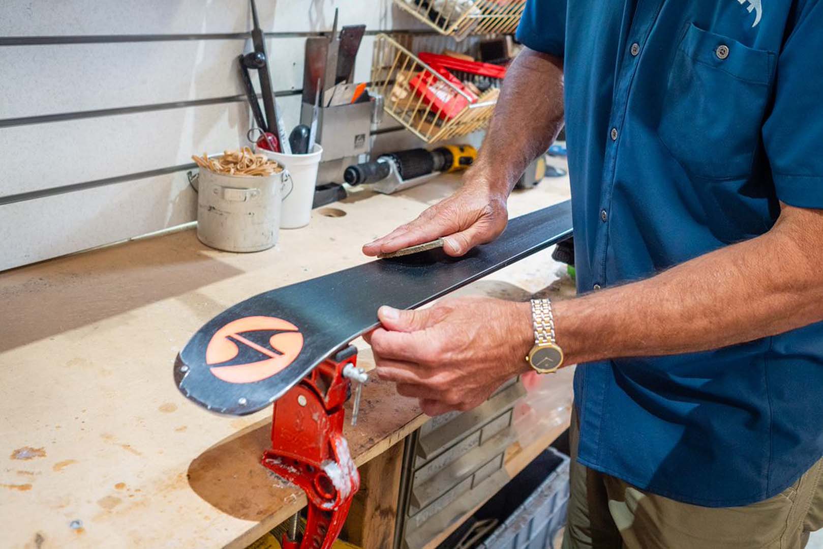 Bud Heishman working on a pair of skis in a ski shop.